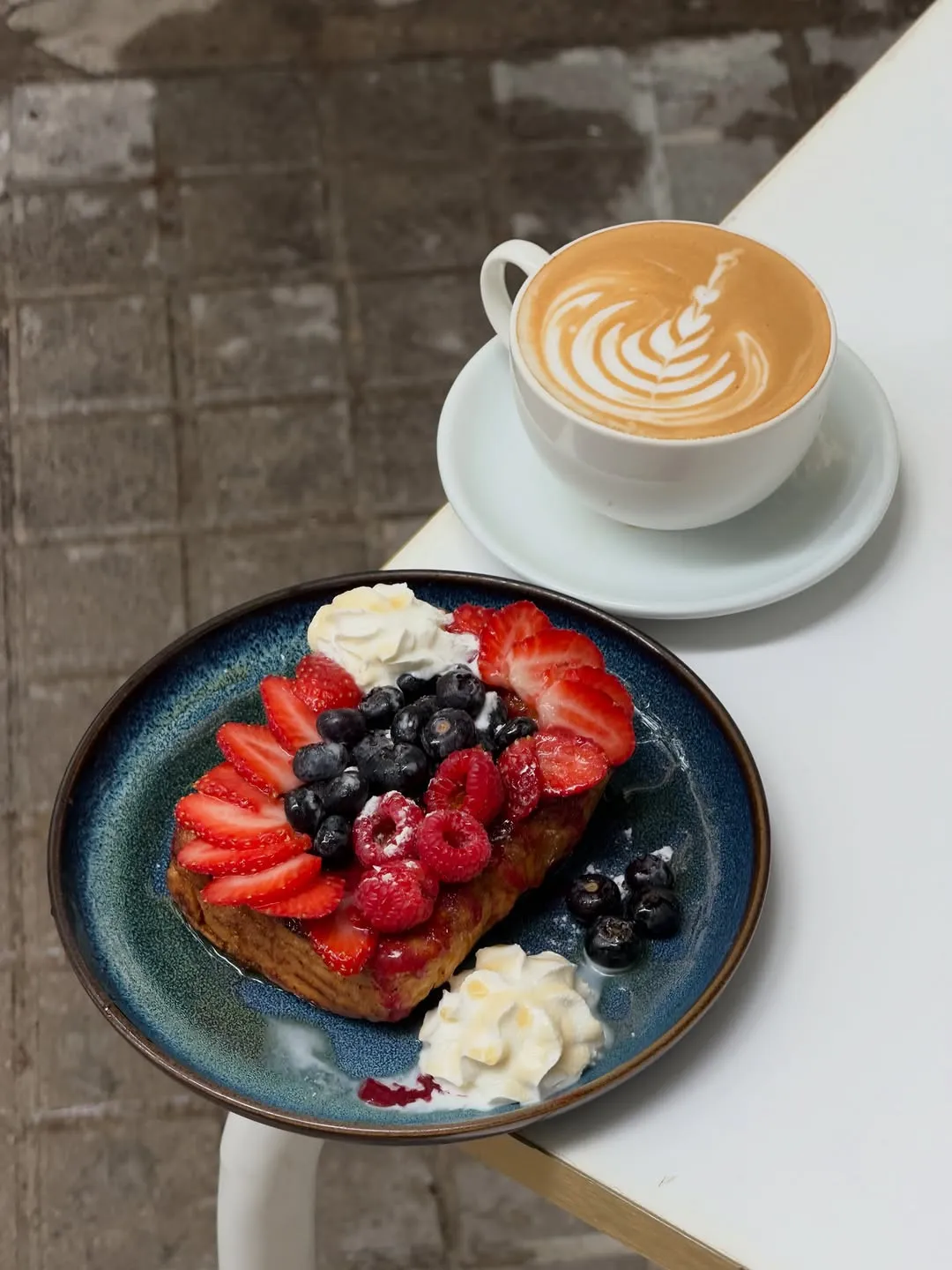 French toast with red berries and a coffee
